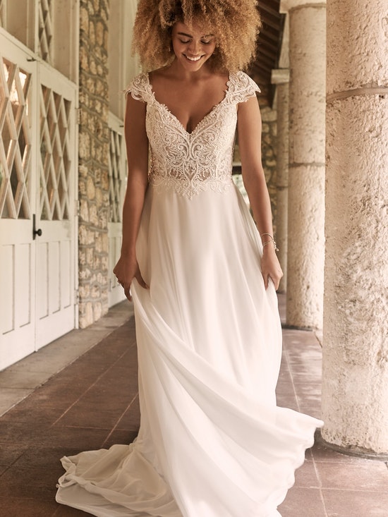 Romantic cap-sleeve chiffon bridal gown with a sweetheart neckline